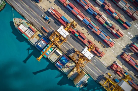 Sustainable retail sourcing and supply chain port with containers. Logistics and transportation of Container Cargo ship and Cargo plane with working crane bridge in shipyard, logistic import export and transport industry background